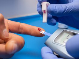 What Is Diabetes? Symptoms, Causes & Prevention Guide Person checking blood sugar using a glucometer at home to manage diabetes and prevent complications