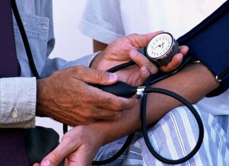 What Is Hypertension? Symptoms, Causes & Prevention Tips Checking blood pressure to detect hypertension early using a digital monitor