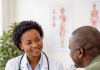 Constipation: Causes, Symptoms, Prevention, and management African doctor explaining constipation prevention to patient in clinic