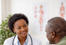African doctor explaining constipation prevention to patient in clinic
