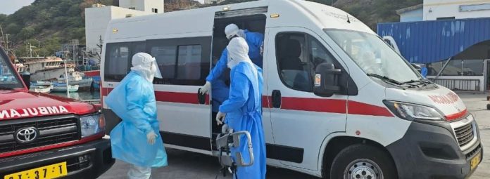 Medical team wearing PPE transferring a patient into an ambulance during emergency infectious disease response